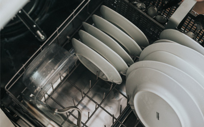 Dishes in a dishwasher that failed and caused flooding