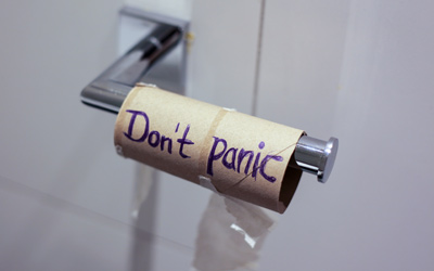 Don't panic written on an empty toilet paper roll humorous note for sewage backup